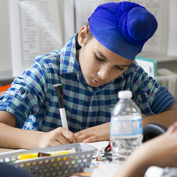 A student works on an assignment during class