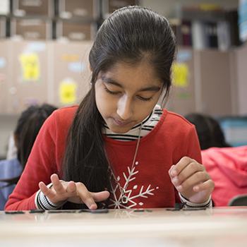 A student works on a word game during class