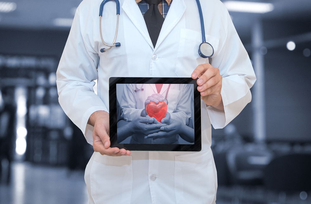 Photo of a doctor holding a tablet
