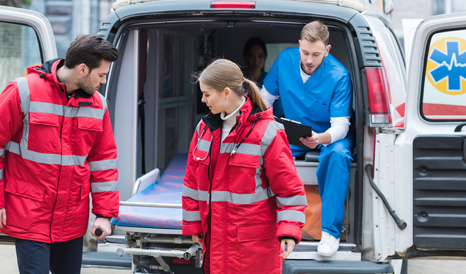 Photo of paramedics lifting a stretcher out of an ambulance