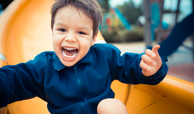 Photo of a young boy on a slide