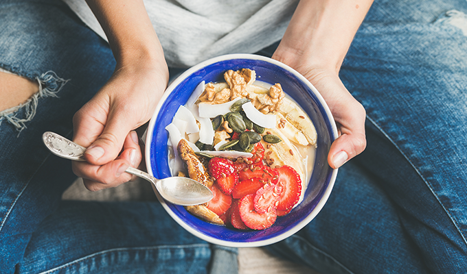 Photo of a woman holding a salad in her lap
