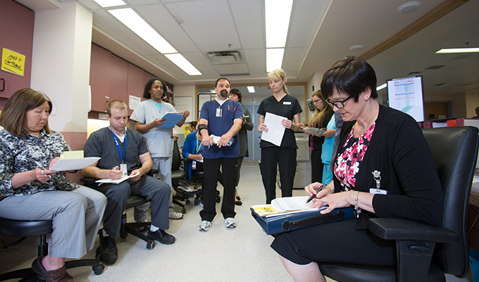 Members of a collaborative care team at Concordia Hospital gather for a Daily Action Round